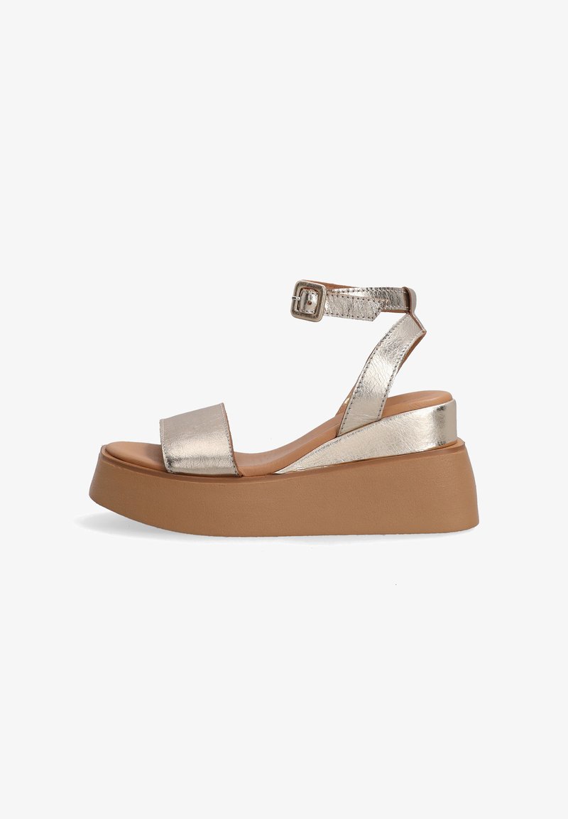 Metallic gold platform sandals with an ankle strap, featuring a wide toe band and textured accents. Light brown rubber outsole.