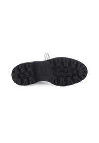 Semelle en caoutchouc noir avec un motif de semelle rugueux, présentant des surfaces de traction en relief et un logo central. Surface lisse accompagnée de contours pour une meilleure adhérence.