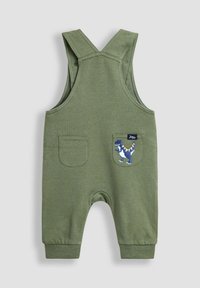 Grüne Baumwoll-Latzhose mit verstellbaren Trägern, zwei Taschen und einer Dinosaurier-Stickerei auf der linken Tasche. Weiches Material, lässiges Design.