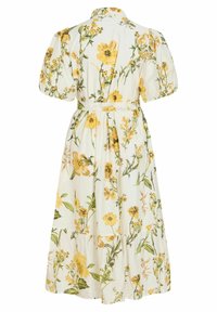 Robe midi blanche avec manches bouffantes, ceinture à la taille et imprimé floral jaune avec feuilles et tiges vertes.
