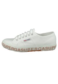 White canvas sneakers with rubber sole, featuring a red "SUPERGA" logo on the side and textured surfaces, rounded toe, and six eyelets.