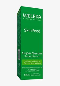 Scatola di cartone verde per il Weleda Skin Food Super Serum; presenta un testo bianco, un codice QR e mette in evidenza ingredienti come ceramide e acido ialuronico.