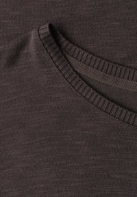 Dark brown knitted fabric with a ribbed crew neck collar and visible inner stitching detail.