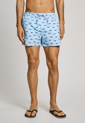 Costumi da bagno azzurri con motivo balene, vita elasticizzata e cordoncino. Presentano una vestibilità comoda e una superficie del tessuto liscia.