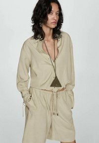 Mango Pantaloni de trening - mottled olive