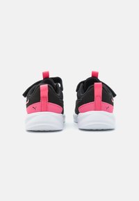 Chaussures de sport noires avec des accents roses, dotées d'un dessus texturé, d'un col rembourré et d'une semelle blanche. Deux languettes à l'arrière pour un enfilage facile.