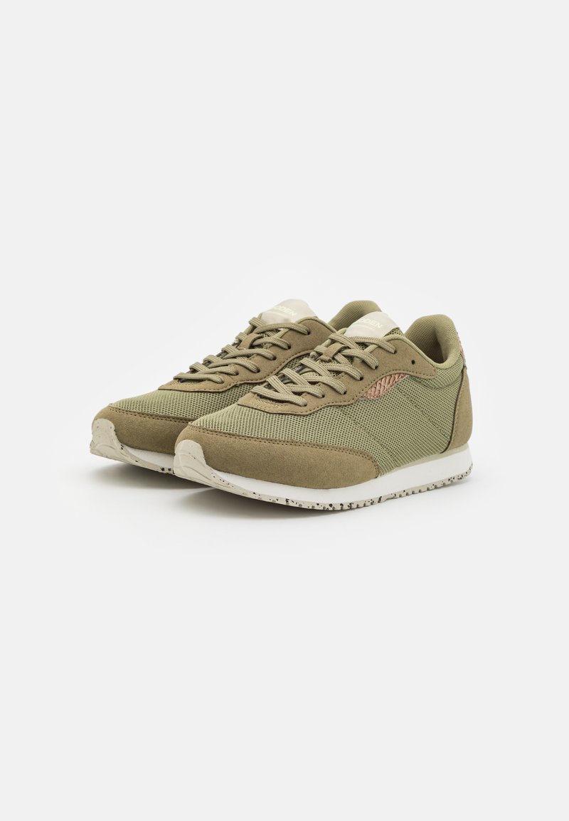 Olivgrüne Sneaker aus Mesh und Wildleder, mit beigen Akzenten, runden Schnürsenkeln und strukturierten Gummisohlen für besseren Halt.