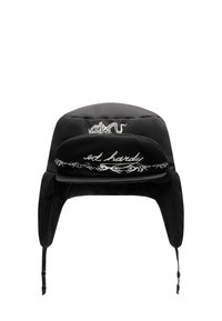 Musta toppattu hattu korvaläppineen, jossa on lohikäärmekuvio ja edessä valkoisella kirjailtu 'ed hardy' teksti.