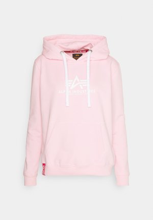 Rosa hoodie i mjukt tyg med en känguruficka, vit logotryck, dragsnoddar och ribbade muddar.