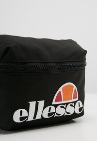 Black fabric bag featuring a top zipper, with a white logo and a colorful graphic logo detail in orange and pink on the side.