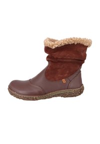 Brune læder- og ruskindsankelstøvle med beige fleece-foring og struktureret gummisål, designet til koldt vejr.