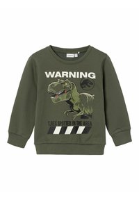 Zelená bavlnená mikina s grafikou dinosaura, textom "UPOZORNENIE" a čierno-bielymi pruhmi. Obsahuje rebrované manžety a výstrih.