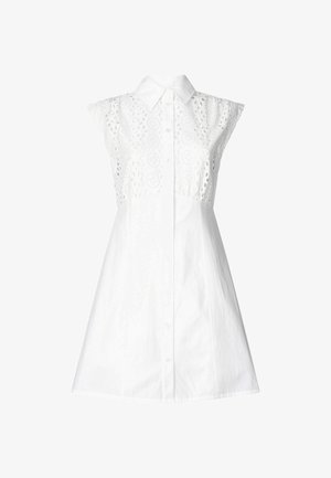Abito bianco senza maniche con colletto a camicia, caratterizzato da dettagli ad ago intricati nella parte superiore e una chiusura frontale con bottoni. Tessuto morbido.