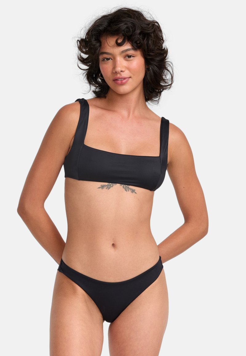 Black bikini set featuring a square-neck top with wide straps and minimal coverage bottoms, crafted from smooth, stretchy material.