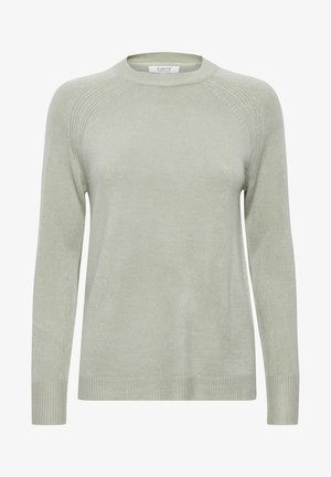 Heled roheline sveter ümmarguse kaelusega, pika varrukaga, ribaga mansettidega ja tekstuuriga kudumise mustriga. Materjal näib olevat pehme ja kergelt läikiv.