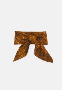 Brown patterned scarf featuring yellow and navy "DADA" text, with a large bow shape and two elongated ends. Made of soft fabric.