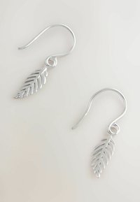 Ezüst levél alakú fülbevalók fényes felülettel, bonyolult részletezéssel és kampós dizájnnal a biztonságos viselés érdekében.