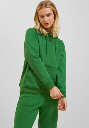 Green hoodie with a drawstring, front pocket, and ribbed cuffs. The material appears soft and slightly textured, featuring a minimalistic design.