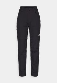 Schwarze Wanderhose mit Reißverschluss zum Abzippen, aus strapazierfähigem Material, mit zwei Seitentaschen, Reißverschlüssen an den Knien und einem Logo am linken Oberschenkel.