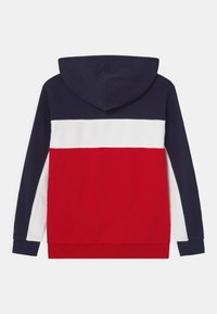 Felpa con cappuccio dal design a blocchi di colore blu navy, bianco e rosso. Presenta maniche lunghe, una tasca frontale e una morbida texture in cotone.