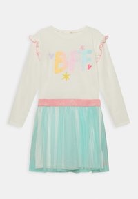 Šaty s dlouhými rukávy a krémovým vrškem, na kterém je nápis "BFF" v třpytivých barvách, s volánovými okraji rukávů a tyrkysovou tylovou sukní s leskem.