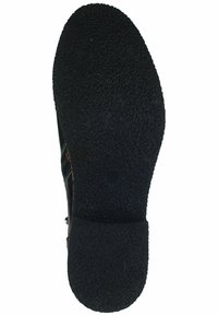 Suola di scarpa in gomma nera con superficie testurizzata, caratterizzata da una forma arrotondata e un leggero tacco. Nota per il suo design di presa a motivo.