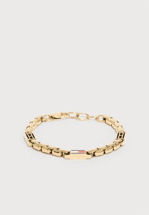 Goldkettchen-Armband mit rechteckigen Gliedern, zwei Blöcken mit eingraviertem "H" und einem zentralen Flaggenemblem in Rot, Weiß und Blau.