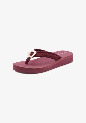 Mauve flip-flop sandal with a thick, textured sole, fabric straps, and a white square buckle detail on the upper strap.