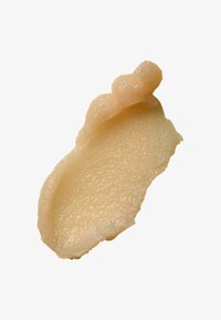 Beige-kerma, jolla on sileä, pehmeä koostumus, muotoiltu terälehdiksi, joissa on aaltoilevat reunat ja hieno kiilto. Ei näkyviä hiukkasia tai jälkiä.