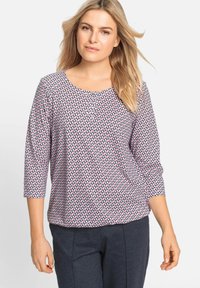 Lightweight, patterned top featuring a round neckline and three-quarter sleeves in pink and black geometric design. Soft, smooth fabric.
