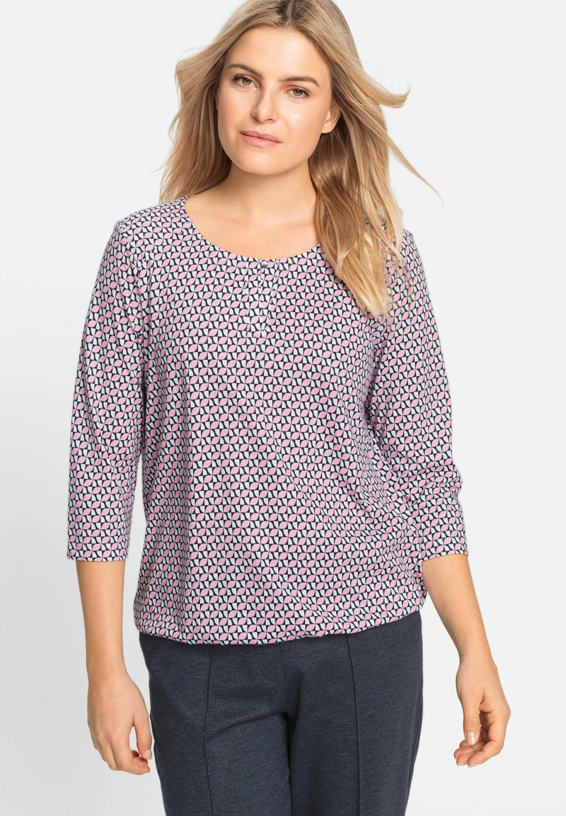 Lightweight, patterned top featuring a round neckline and three-quarter sleeves in pink and black geometric design. Soft, smooth fabric.