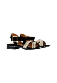 Black and beige sandal featuring soft fabric straps, woven detailing across the forefoot, and a low, sturdy black heel. Buckle closure at the ankle.