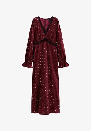 Abito midi bordeaux a maniche lunghe con pois bianchi, scollatura a V bordata di pizzo nero e polsini arricciati.