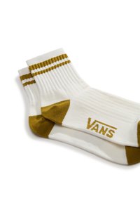 Weiße Socken mit geribbelter Textur, die oben zwei braune Streifen und eine braune Fußspitze haben. „VANS“-Logo in Gold an der Seite.