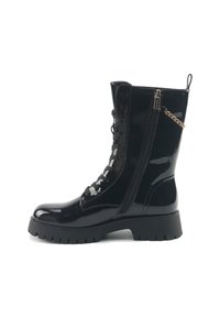 Stivale militare in pelle patent nera con suola chunky, lacci frontali, cerniera laterale e dettaglio decorativo in catena dorata sulla parte superiore.