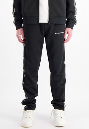 TAPED - Tracksuit bottoms - black