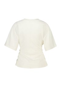 Light beige short-sleeve T-shirt with a loose fit. Features a round neckline, subtle side gathers, and a smooth cotton texture.