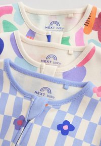 Trois grenouillères pour bébé NEXT pliées avec des motifs colorés comprenant des formes abstraites, des rayures et des fleurs dans des couleurs pastel.