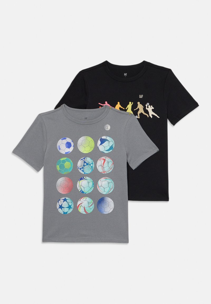 Two short-sleeve t-shirts: one grey with multicolored soccer balls, one black with colorful silhouettes of soccer players.