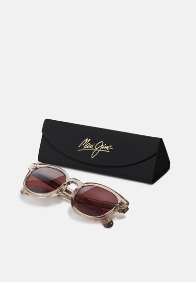 Clear, oversized sunglasses with dark red lenses, featuring a transparent frame. Includes a black case with gold logo.