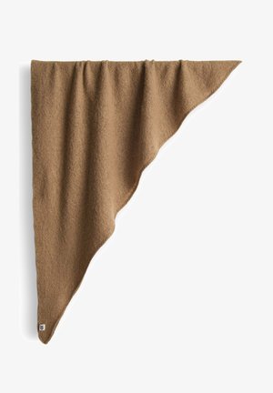 Braune Wolldecke mit unregelmäßigem, fließendem Rand. Weiche Textur und dezente Details. Markenetikett an der unteren Ecke.