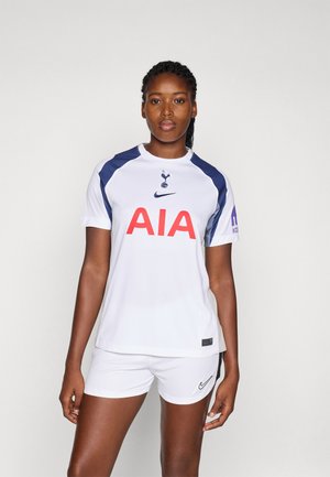 White football jersey with navy accents, featuring a large red "AIA" logo and a Nike swoosh. Paired with white shorts and black detailing.