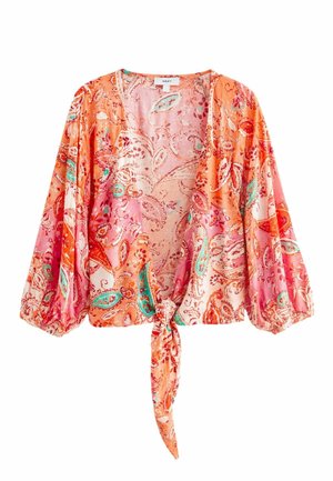 Blouse à manches longues, courte, avec un motif paisley orange, rose et turquoise, comprenant un nœud à nouer devant et des poignets froncés.
