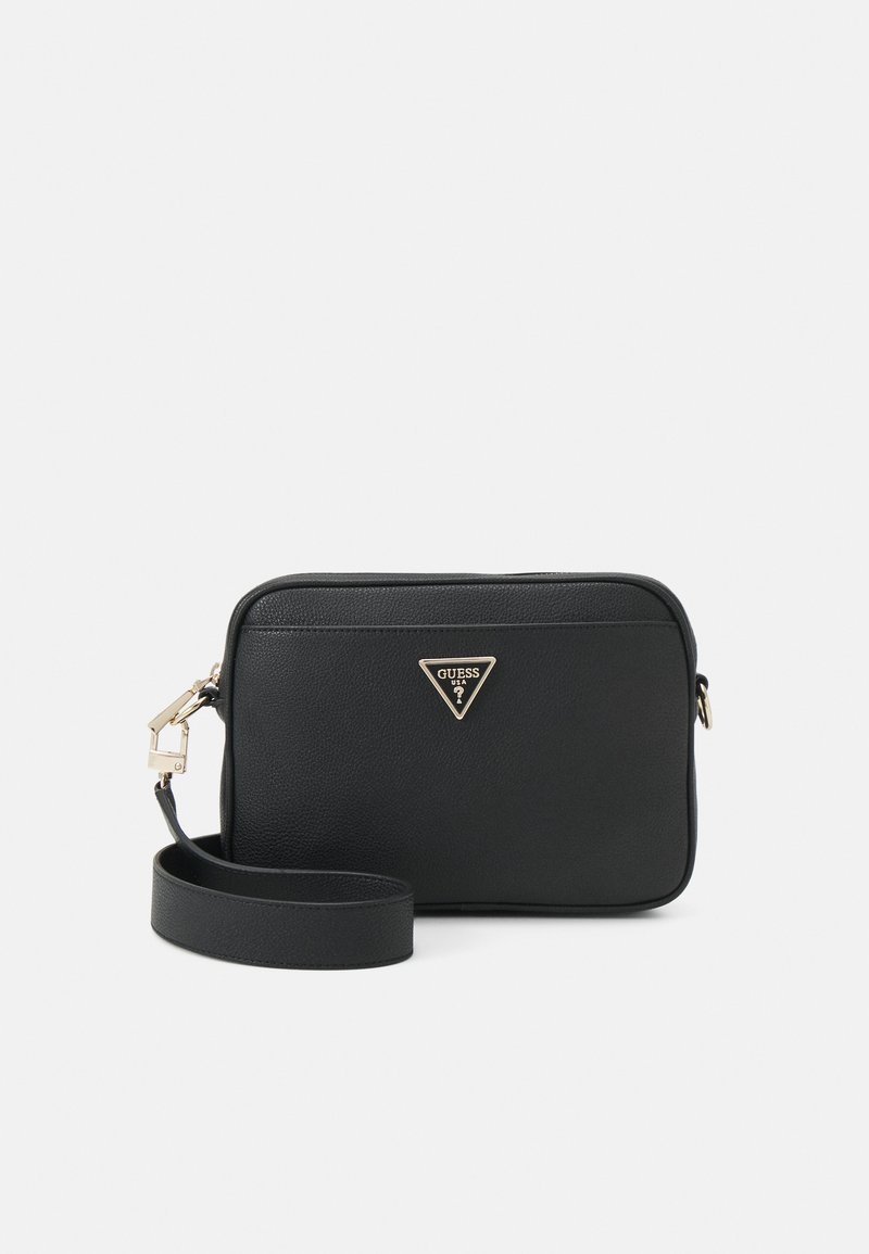 Black synthetic leather crossbody bag with a textured surface, gold triangular logo, zip closure, and an adjustable strap.