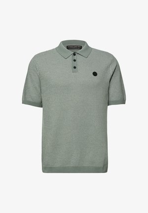 Vihreä, lyhythihainen poolopaita, jossa on teksturoitu neulos, kolmen napin aukko ja vasemmassa rinnassa musta pyöreä logo.