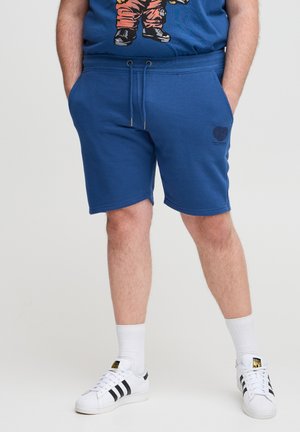 Blauwe katoenen shorts met een elastische tailleband, een trekkoord en zijzakken. Heeft een klein hartlogo op het linkerpunt.