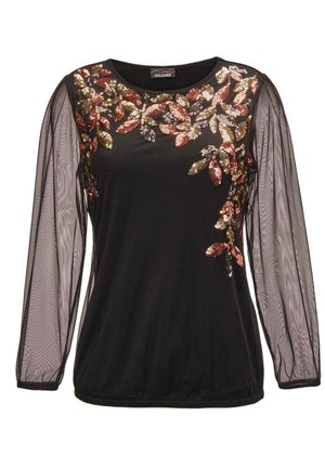 Schwarzes Oberteil mit transparenten Mesh-Langärmeln, verziert mit bunten, mit Pailletten besetzten Blattmustern in Rot, Gold und Silber am Ausschnitt.
