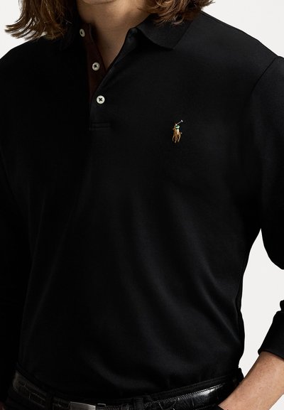 Black cotton polo shirt with a three-button placket. Features a small, embroidered rider logo on the left chest and long sleeves.
