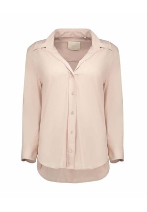 Chemisier rose clair à manches longues avec boutons, col pointu et ourlet légèrement arrondi.
