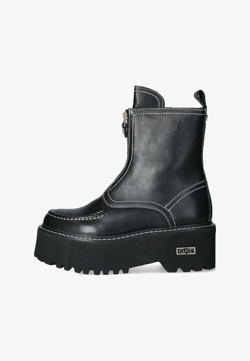 Stivale alla caviglia in pelle nera con suola piattaforma alta, cuciture bianche a contrasto, zip frontale e suola in gomma testurizzata.